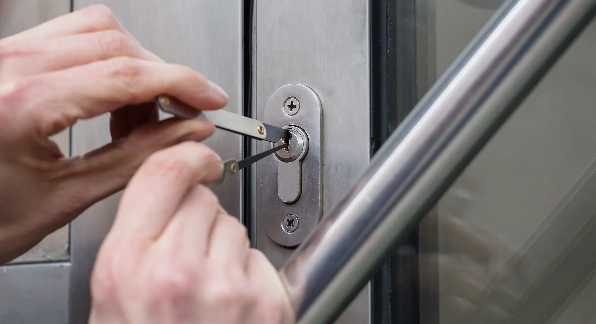 A person opening a door with a pair of scissors.