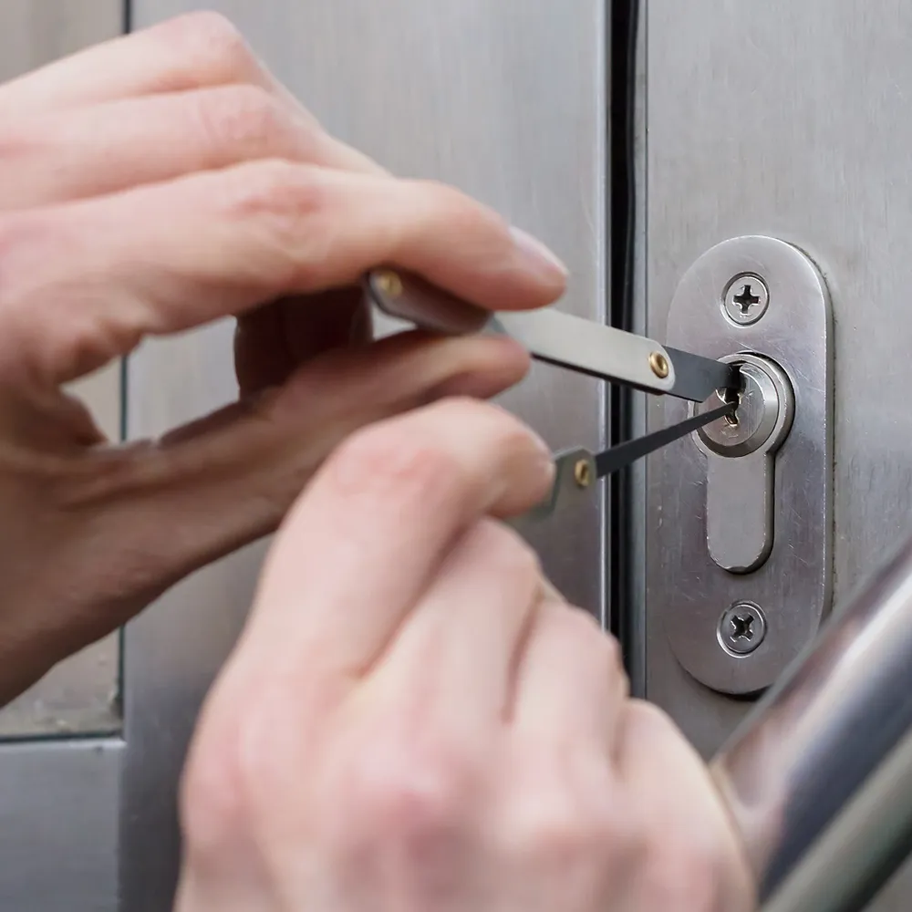 A person using a pair of scissors to open a door.